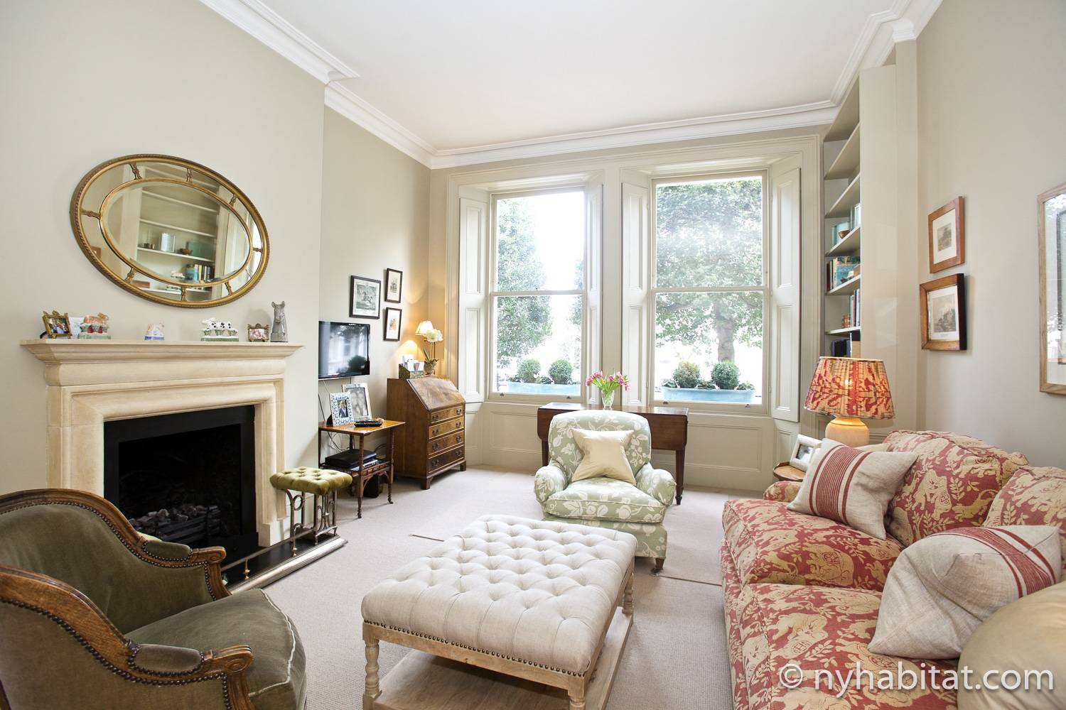 Image of living room in LN-1956 with armchairs, decorative fireplace and sofa.
