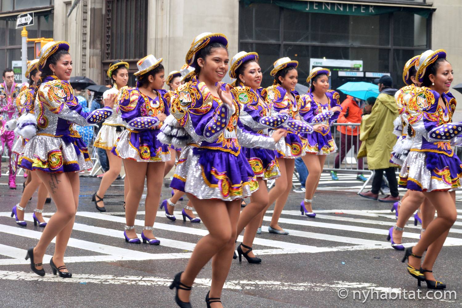 Image of dancers in purple costumes dancing in the New York City Dance Parade.