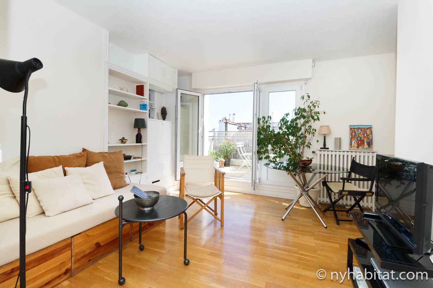 Image of living area in PA-3384 with sofa, chairs, tables, and bookshelf.