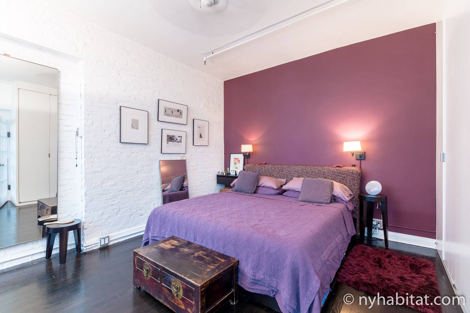Image of bedroom in NY-12330 with king-sized bed, side tables, and artwork.