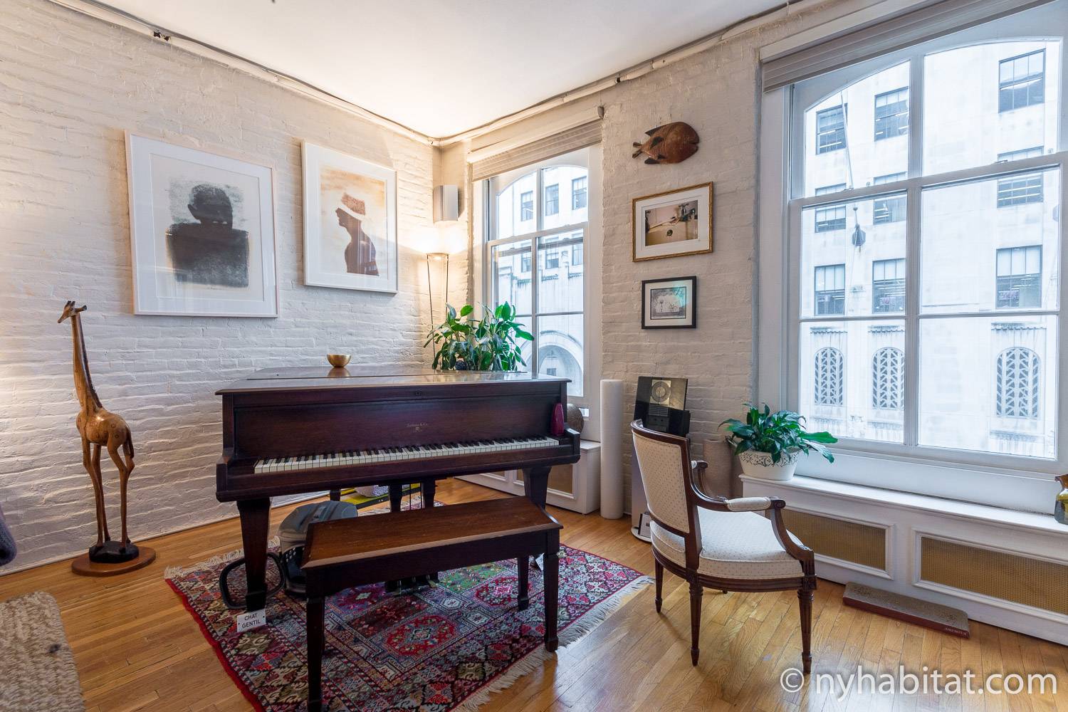 Image of living area in NY-12330 with grand piano, windows and artwork.