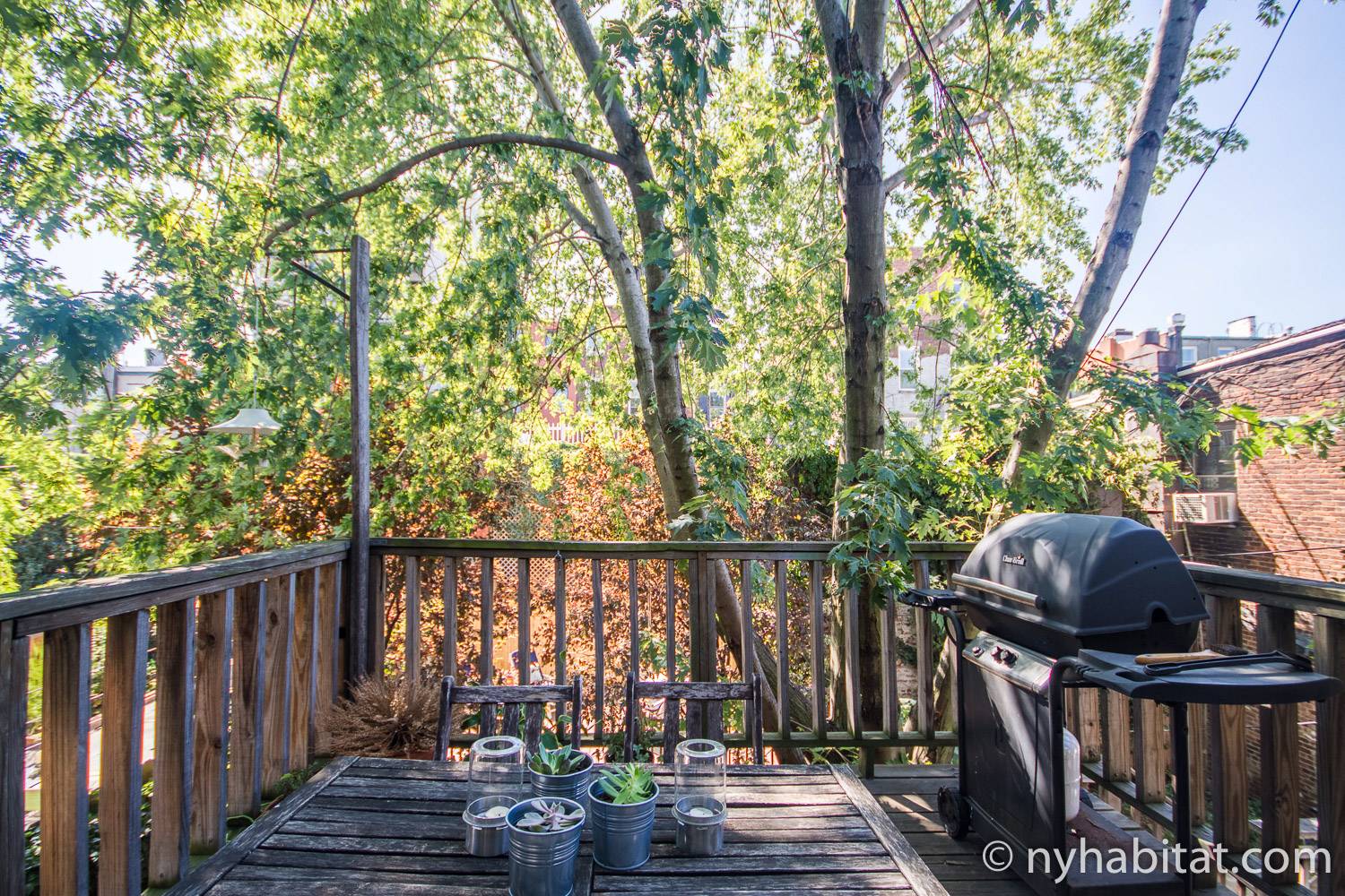 Image of backyard patio outside NY-15411 with grill and table and chairs.