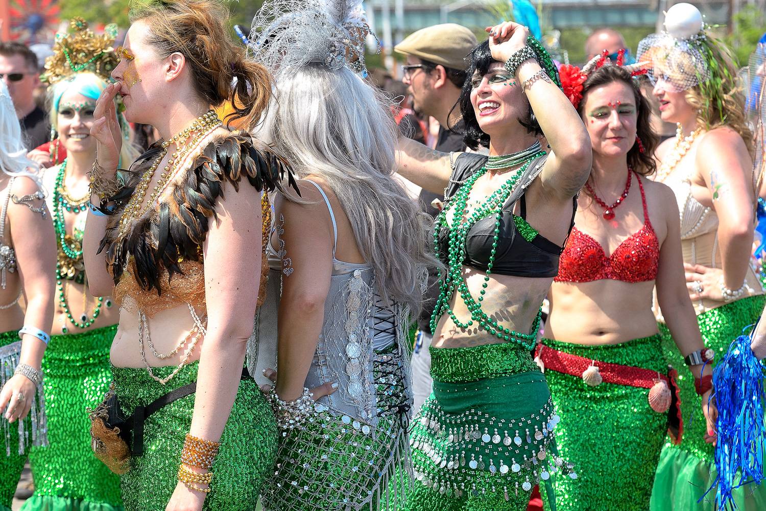 Image of marchers in the Coney Island Mermaid Parade in mermaid costumes.