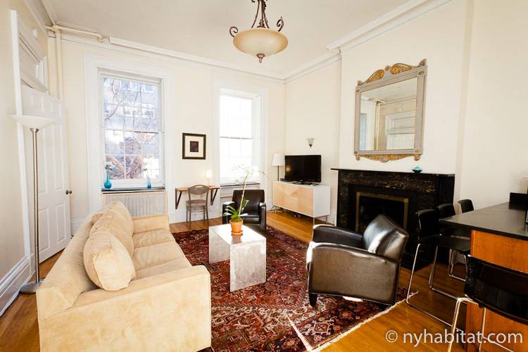 Image of living area in NY-15085 with armchairs, sofa, and decorative fireplace.