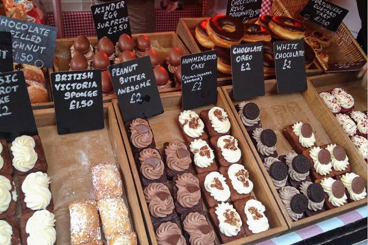 Image of desserts and pastries on display at a London bakery stall.