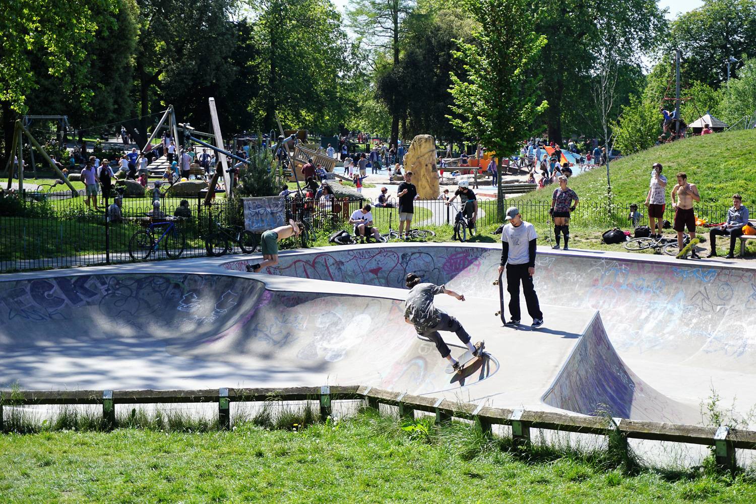 Image of skateboarders on a summer day at the skatepark in Clissold Park, Hackney.