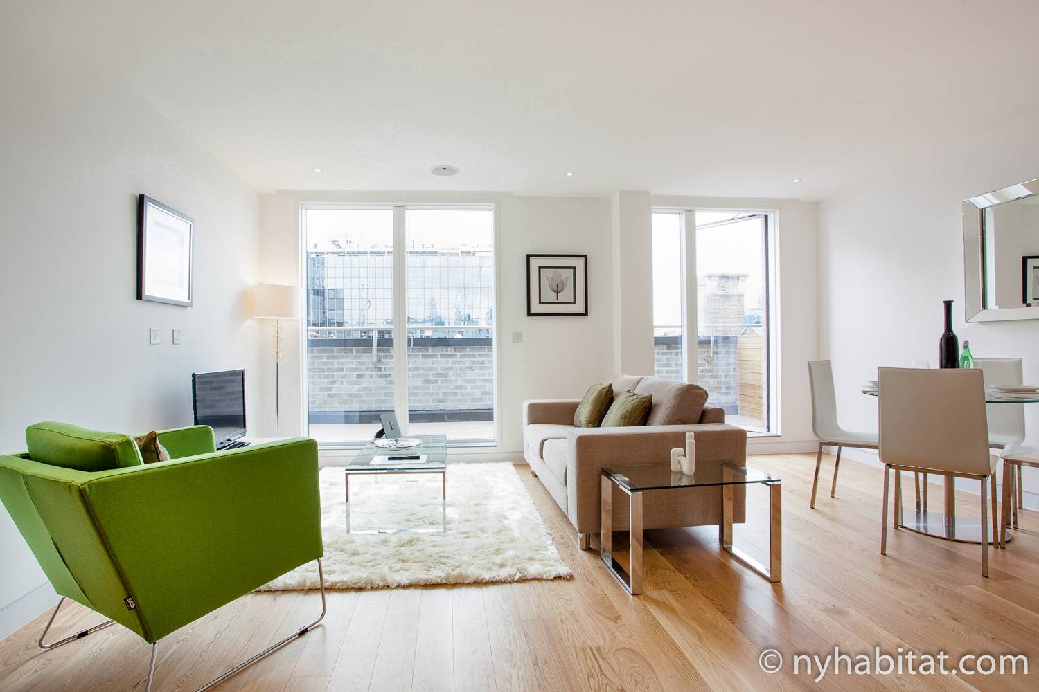 Image of living area in LN-1492 with sofa, armchair, and dining table and chairs.