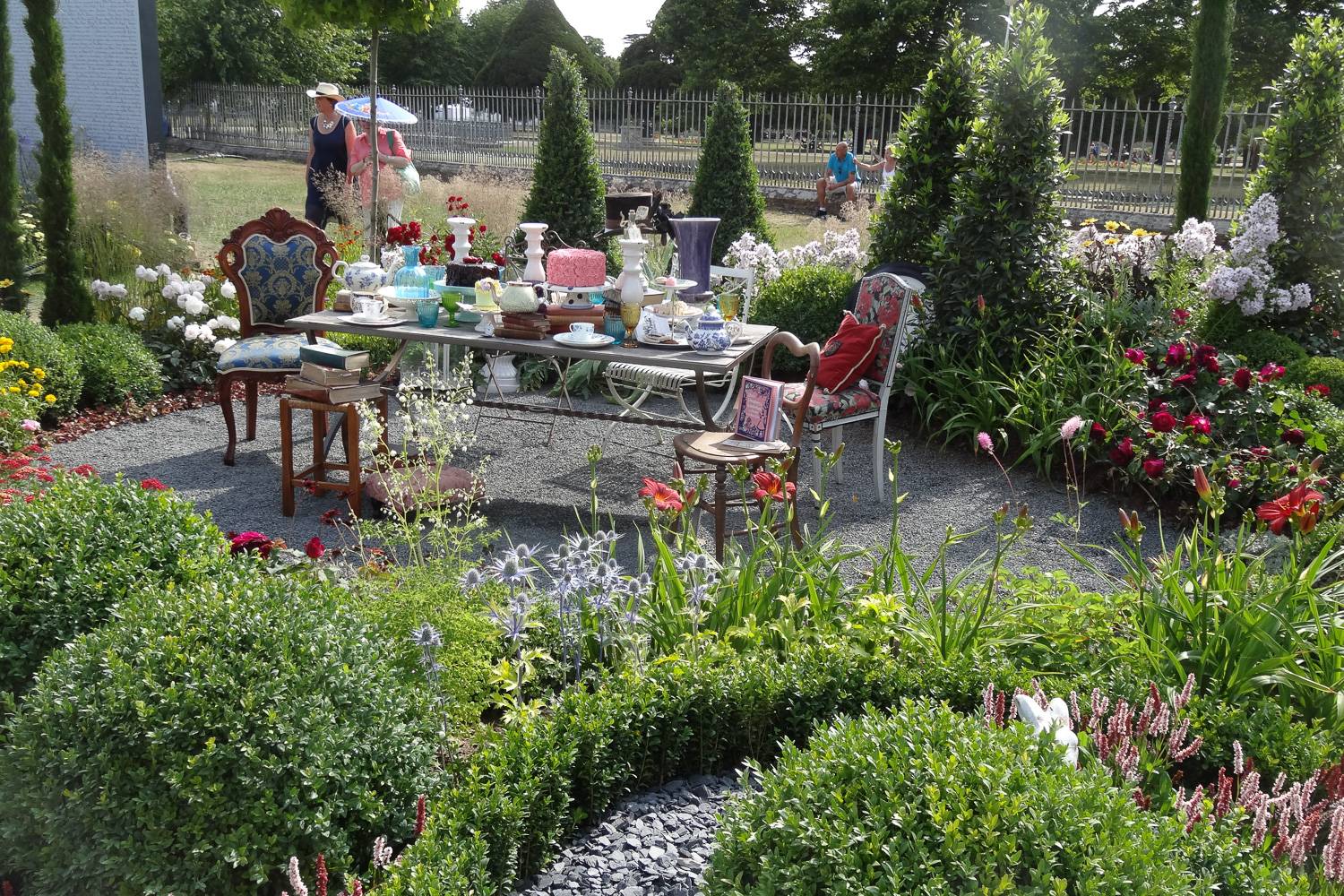 Image of a display at the RHS Hampton Court Palace Garden Festival of a tea set surrounded by flowers.