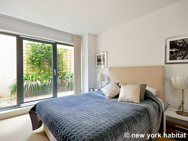 Image of bedroom in LN-1240 with queen-sized bed and sliding doors to terrace