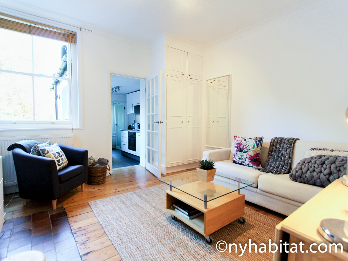 Image of living area in LN-24 with white sofa and armchair.