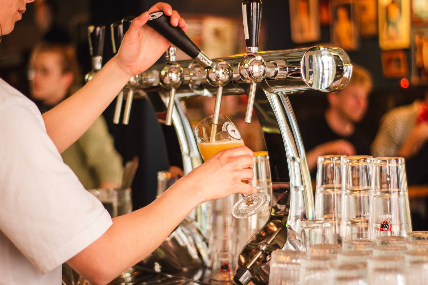 Image of a man pouring beer from a tap.