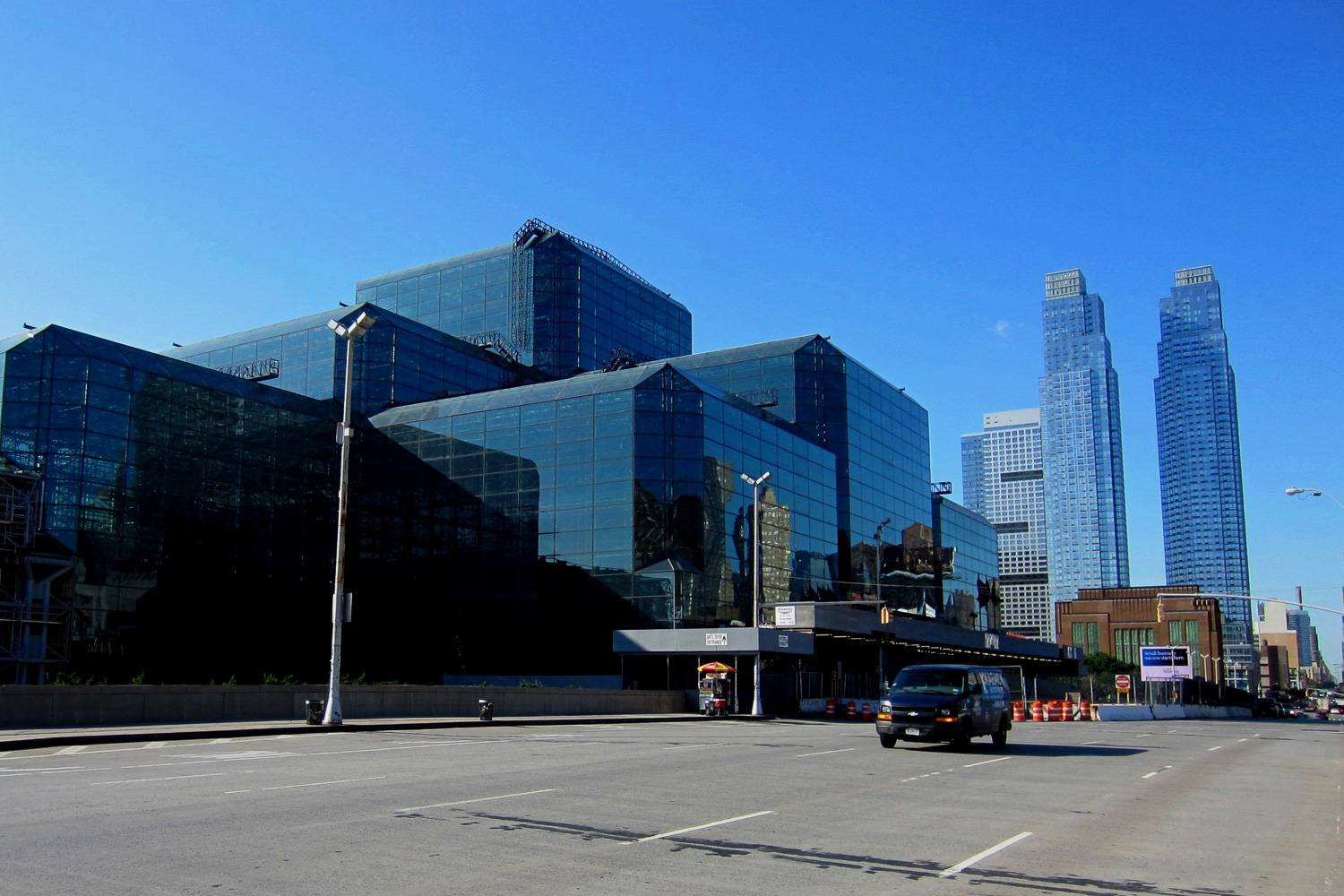 Image of the outside of the Jacob K. Javits Convention Center that is mainly constructed out of blue glass windows.