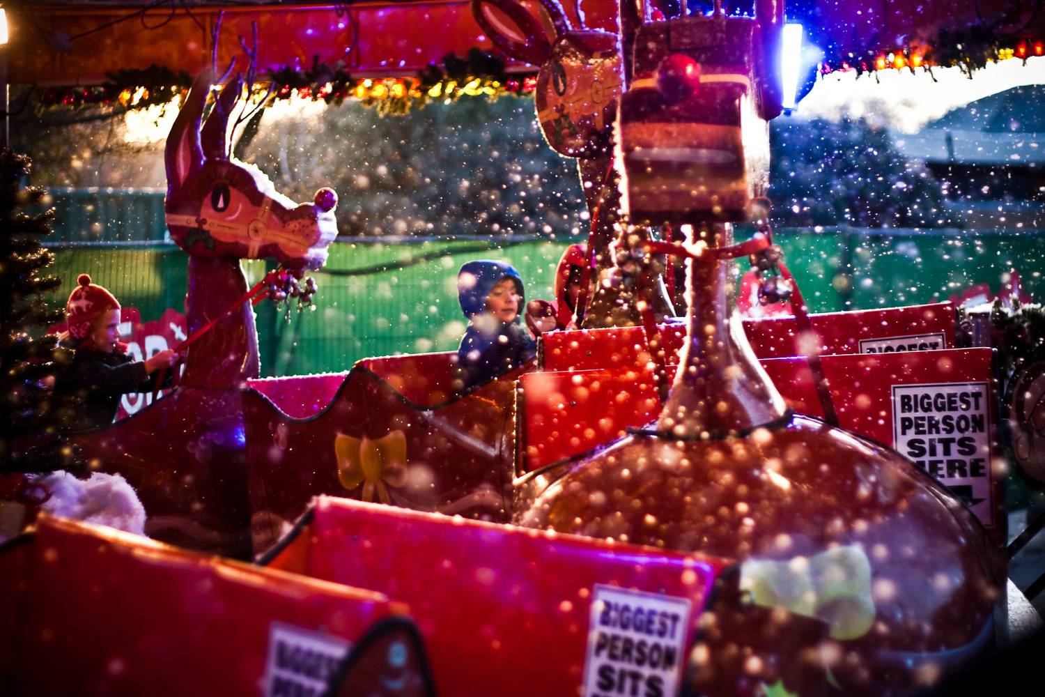 An image of a child riding a reindeer-themed attraction at Hyde Park.