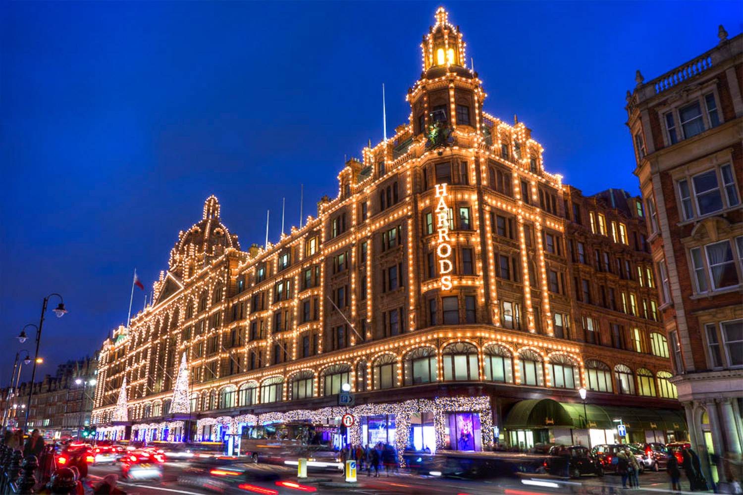 An image of the luxury emporium, Harrods, decorated in festive holiday lights in Knightsbridge, London.