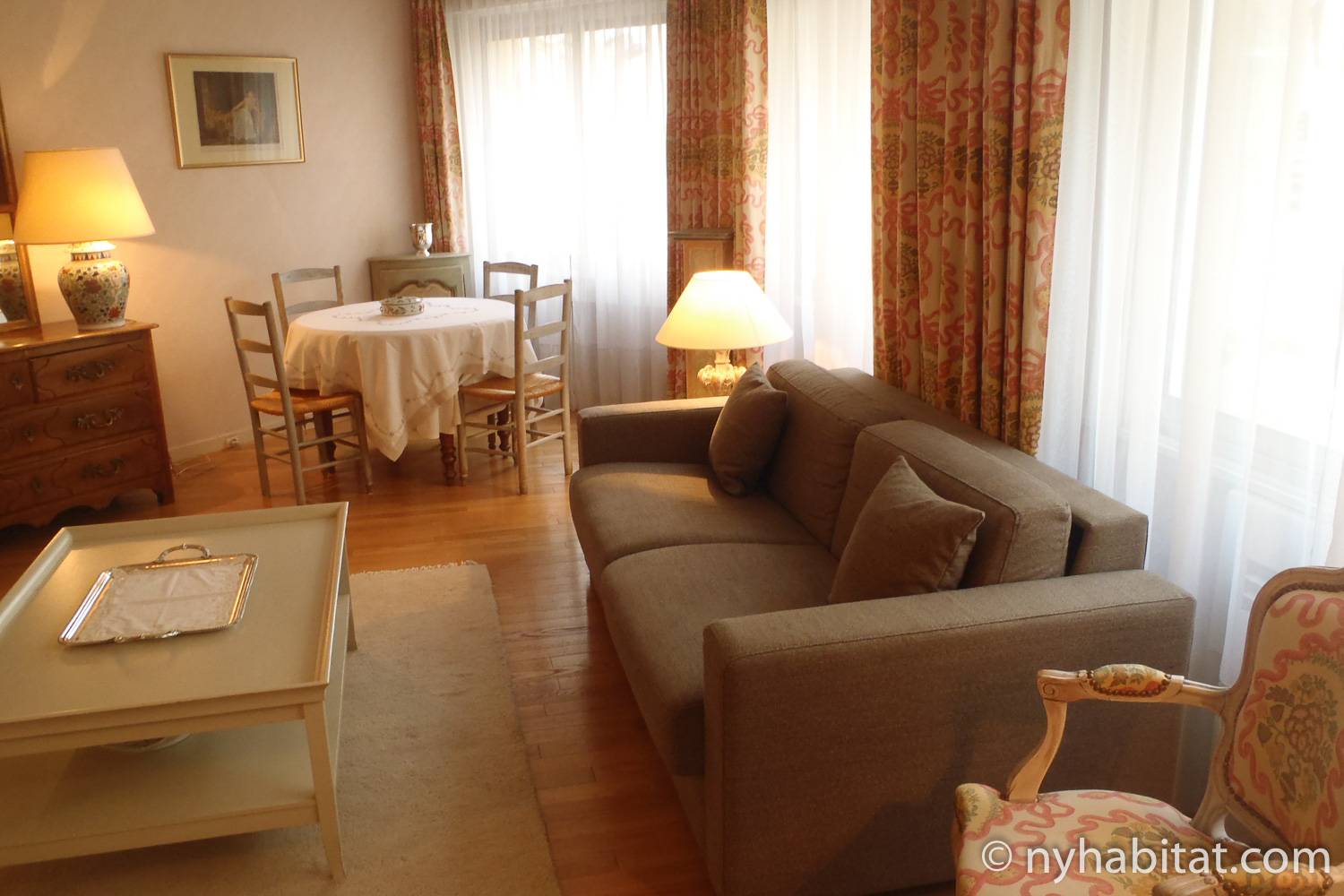 Photo du salon de l’appartement PA-1656 avec canapé, table à manger et chaises.