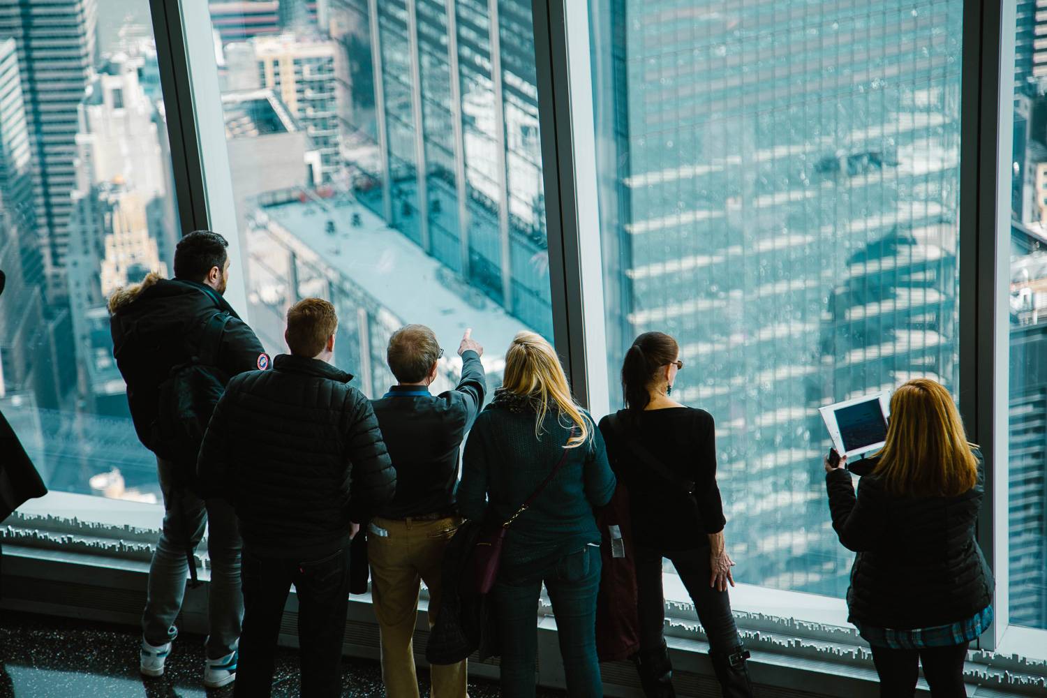 Photo de personnes regardant par les fenêtres du One World Observatory.