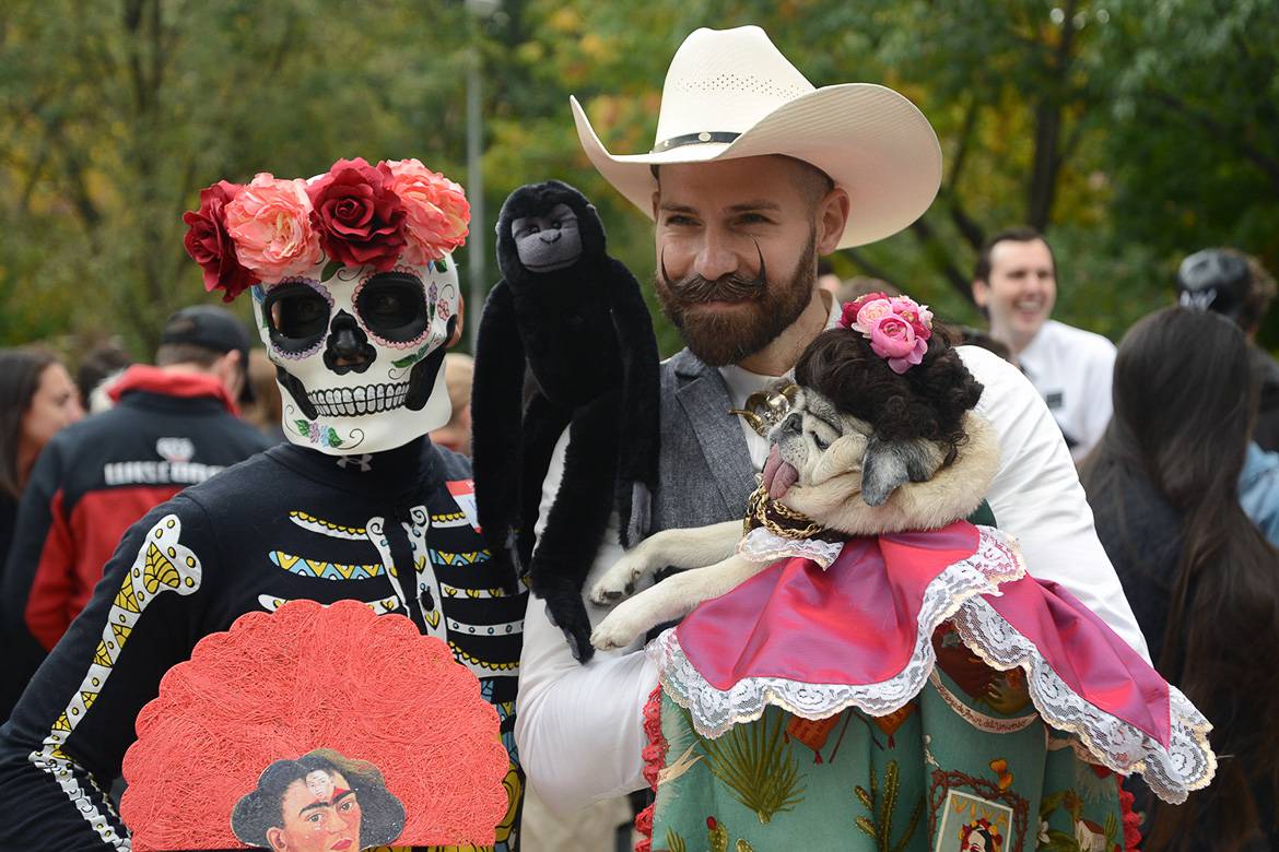 Immagine di una coppia e un cane con costume da Halloween nell’East Village