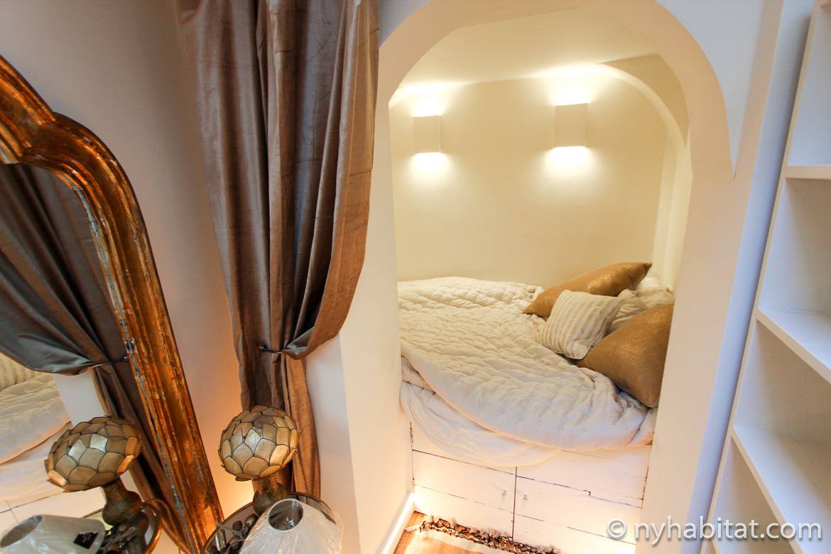 Imagen de un dormitorio con un arco y cortinas doradas del apartamento LN-1725